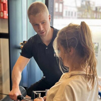 Physiotherapist provides coaching to a client during rehabilitation therapy at the practice.