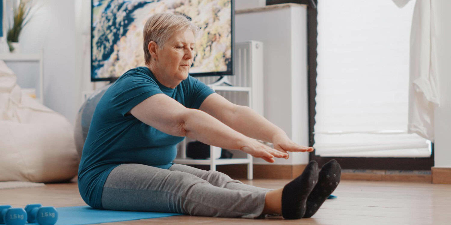 Woman with parkinson's tries to stay active by doing exercises at home