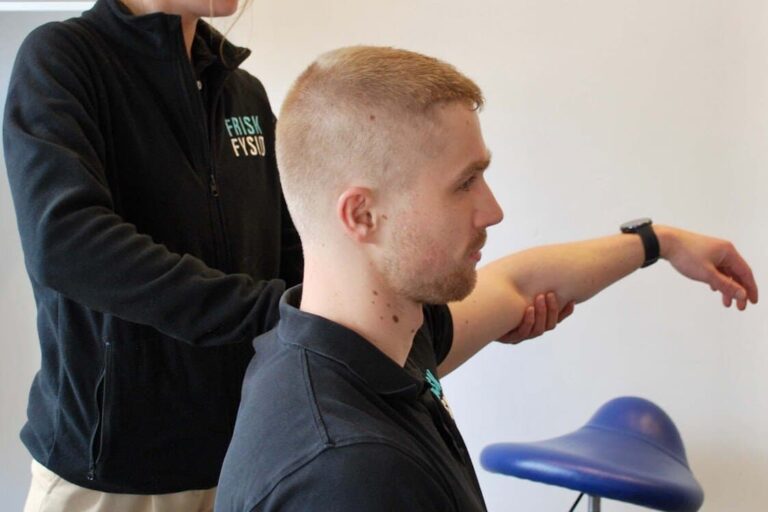 Fysiotherapeut die een man begeleidt bij schouderrehabilitatie na peesontsteking, gericht op herstel en pijnvermindering.