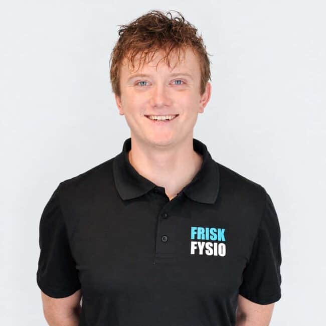 Man wearing a black FRISK FYSIO polo shirt and glasses, looking professional, against a white background.