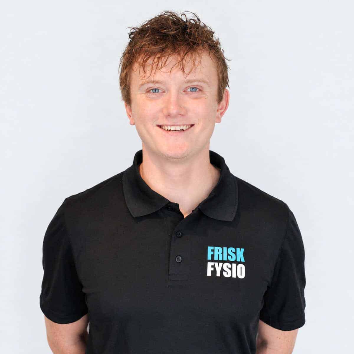 Man wearing a black FRISK FYSIO polo shirt and glasses, looking professional, against a white background.