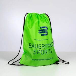 A light green sports bag with a drawstring fastening and dark blue branding, featuring the Buerenhof Sports logo and the hashtag #FORYOURPERSONALBEST.