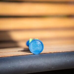 A blue medicine strip bearing the brand name Lozol on a wooden surface, clearly in focus whilst the background is blurred.