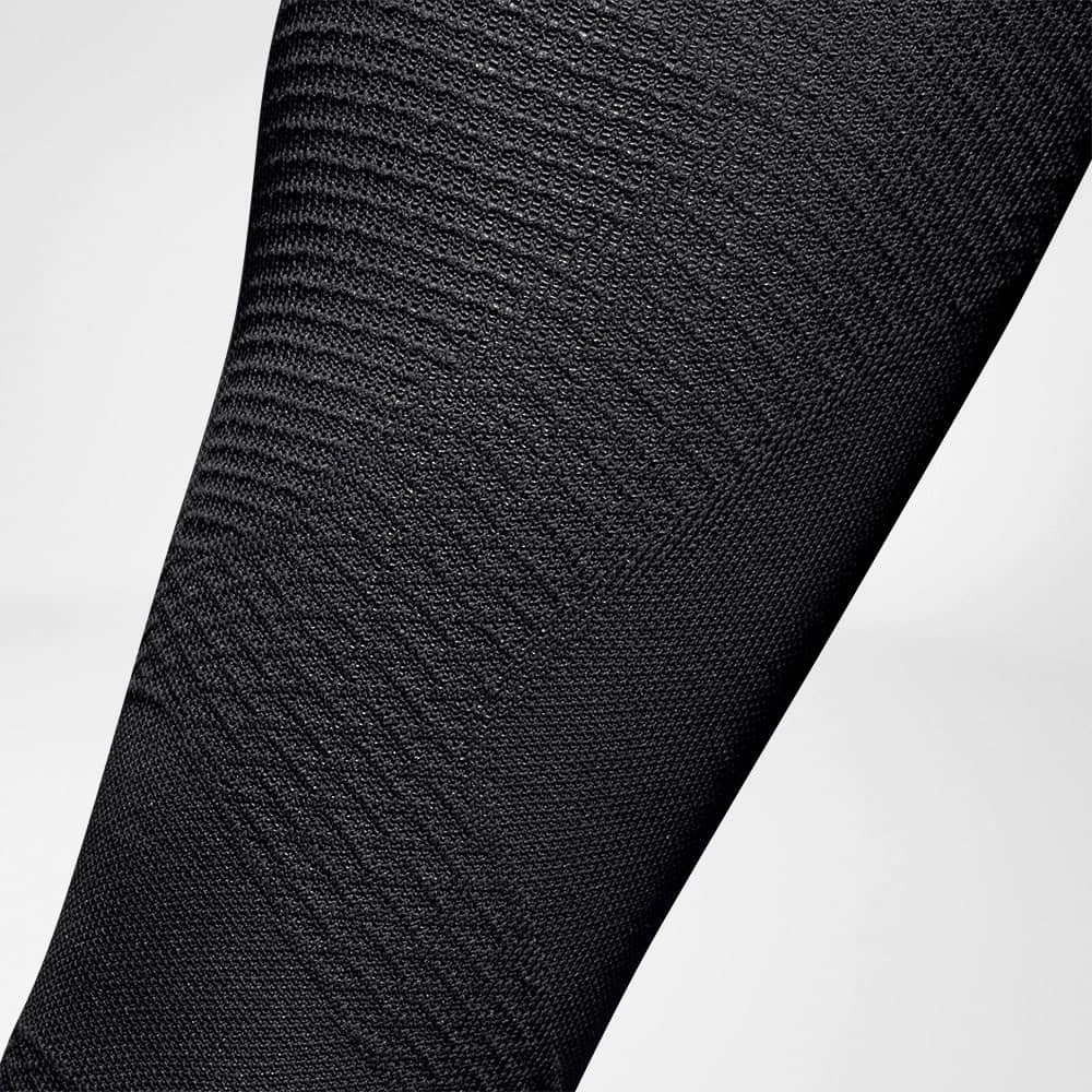 Run Ultralight Compression Socks 5 Tight-fitting, elastic garment worn next to the skin for sport and physiotherapy; close-up of the texture and weave pattern.