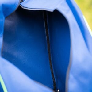 Inside view of a blue rucksack with a zip, a close-up photo highlighting its texture and quality.