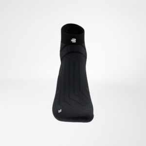 Sportieve zwarte sok met stretchy compressie enJ-achtige patroon, detail van enkelzone en logo op bovenkant.