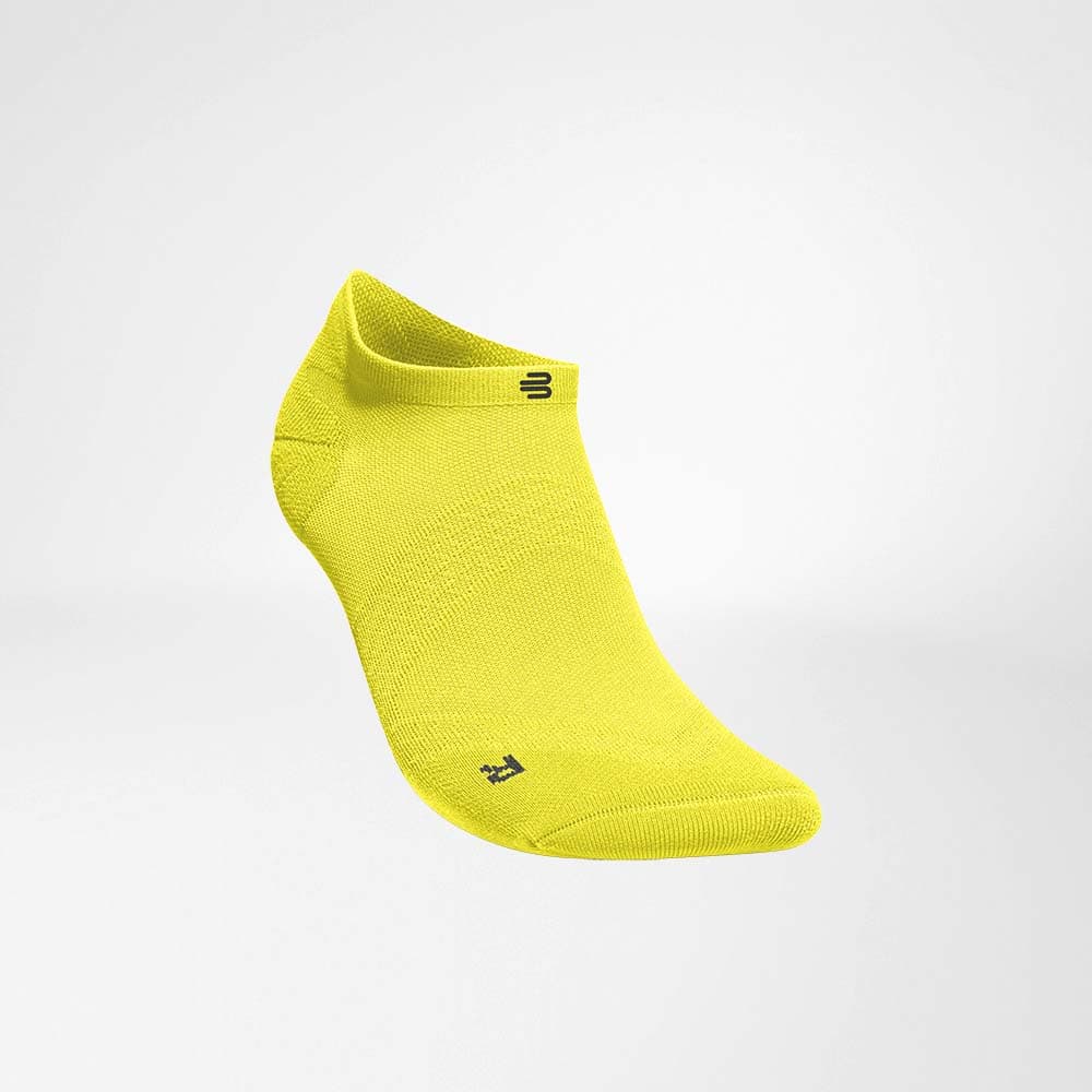 Run Ultralight Low-Cut Socks 2 A bright, vividly coloured yellow ankle-length sock with a low cuff and minimal branding, designed with a sports and physiotherapy theme in mind.
