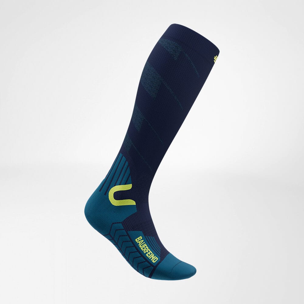 Ski Touring Compression Socks 1 Frisk Fysio sports socks in dark blue with teal accents and yellow details, long-lasting stretch, knee-high, professional sports compression.